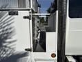 A 2006 International 4300 truck featuring a service box with several tubular attachments on the side and a step for access to the truck bed