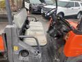 A 2010 Kubota RTV 900 with small front seats and a steering wheel featuring various controls and gauges