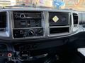 Interior dashboard of a 2015 Hino 358 featuring audio controls climate settings and an empty slot for a CD or media player