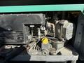 Engine compartment of a 2012 Ford Econoline E-450 showing components like the engine block service information and various mechanical parts