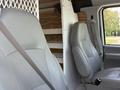 Interior view of a 2008 Ford Econoline with two gray seats and a partition dividing the cargo area from the front seats