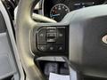The steering wheel of a 2021 Ford F-150 featuring control buttons for settings and cruise control