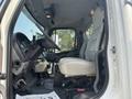 Side view of a 2010 Freightliner M2 106 truck's cabin showcasing the driver's seat steering wheel and dashboard