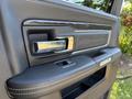 Close-up of the interior door handle and armrest of a 2018 RAM 3500 featuring chrome accents and a leather finish