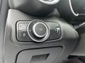 Control panel of a 2023 Alfa Romeo Giulia featuring knobs and buttons for adjusting lighting and other vehicle functions
