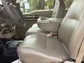 Interior view of a 2008 Ford F-550 showing the leather driver's seat and console with cup holders