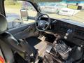 Interior view of a 2017 Chevrolet Express showing the driver's seat dashboard and controls with a gear shifter and steering wheel