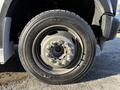 A close-up view of a 2009 Ford F-550 wheel featuring a black rim and a tire with visible tread patterns and lug nuts