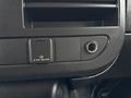 Dashboard panel of a 2021 Chevrolet Express showing a power outlet and a headphone jack
