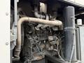 Close-up view of the engine of a 2009 UD Trucks UD 3300 featuring various metal components including pipes wiring and engine block