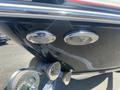 Close-up of a 2013 Larson 238 boat showing chrome accents a light fixture and a horn mounted on the hull