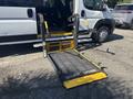 A yellow folding wheelchair ramp extends from the side of a 2020 RAM ProMaster 3500 van designed for accessibility