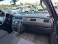 Interior view of a 2011 Chevrolet Avalanche dashboard featuring controls for audio and climate, a sleek design, and spacious seating area