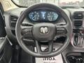 Steering wheel of a 2023 RAM Promaster 3500 featuring the RAM logo and various controls on the sides