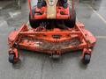 A 2010 Kubota F3680 lawn mower featuring a wide mowing deck with a collection of leaves and debris on the surface and large rear wheels for maneuverability