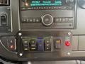 Control panel of a 2020 Chevrolet Express featuring various buttons for interior lights, door controls, and a shift lock system