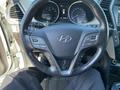 A 2018 Hyundai Santa Fe steering wheel with buttons for controls and settings visible along with the instrument cluster behind it