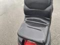 Black seat of a 2017 Ferris Rotary mower showing some wear and tear with smooth surface and slight creases