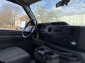 Interior view of a 2011 Ford Econoline showing the dashboard including controls for audio and climate along with front seats and cup holders