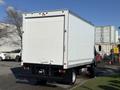 A white 2014 Hino 195 box truck is parked with its back facing the viewer showcasing its smooth rear panel and bumper