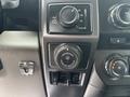 Control panel with knobs and buttons from a 2017 Ford F-150 including settings for traction and trailer backup