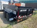 A black 2022 Southland 10-foot dump trailer with the name "Mechanical Ltd" and a phone number on the side, featuring dual axles and shiny black wheels