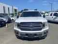 A white 2019 Ford F-150 truck facing forward with a chrome grille and distinctive headlights