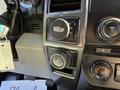 Interior controls of a 2018 Ford F-150 including a climate control knob and four-wheel drive selector