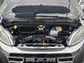 A 2023 RAM Promaster 3500 engine compartment displaying various components including the engine battery and fluid reservoirs