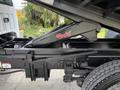 A 2017 Ford F-750 chassis with a Rugby hydraulic dump mechanism prominently displayed