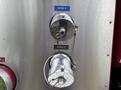 Two metal discharge valves labeled Discharge 3 and Discharge 4 with attached cables on a silver panel