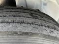 Close-up of a worn tire from a 2012 International DuraStar 4300 showing tread patterns and signs of use