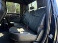 Interior view of a 2021 RAM 3500 showing the back seat with black leather seating and seatbelts in place