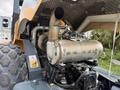 A 2020 Hyundai HR110C excavator with a visible engine compartment featuring a large metallic exhaust system and various engine components