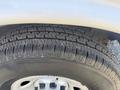 Close-up of a tire from a 2017 Chevrolet Express showing tread patterns and visible wear on the rubber surface