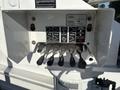 Control panel for a 2006 Freightliner M2 106 featuring levers and buttons for operating the boom arm and rotation functions