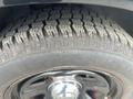 A close-up view of a tire from a 2015 Dodge Charger featuring a Firestone brand with visible tread patterns
