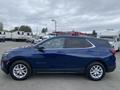 A blue 2022 Chevrolet Equinox parked with a sleek design and alloy wheels visible from the side angle