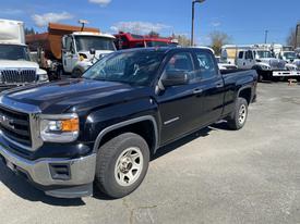 A black 2014 GMC Sierra 1500 pickup truck with a crew cab and chrome accents parked on a lot
