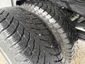 Close-up of two large tires from a 2013 Chevrolet Silverado 3500HD showcasing deep treads and rugged texture