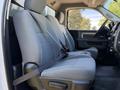 Interior view of a 2016 RAM 5500 showing the front seats with gray upholstery and a seatbelt attached