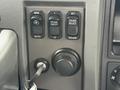 The image shows the control panel of a 2016 Peterbilt 348 featuring buttons for manual and automatic settings cruise control and a key ignition slot