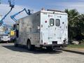 A 2008 Workhorse W62 vehicle with an aluminum exterior featuring various tool designs and a rear door with multiple access points