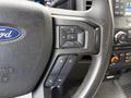 Close-up of the steering wheel of a 2017 Ford F-350 SD featuring control buttons for volume and other audio functions