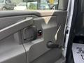 Interior view of a 2020 Chevrolet Express door panel featuring a door handle a window control switch and a manual door lock lever