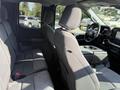 Interior view of a 2021 Ford F-150 showing the back seats with grey fabric upholstery and a console in the center