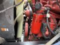 A close-up view of a 2011 Ford F-650 engine highlighting a red fuel filter and surrounding mechanical components