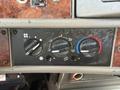 Dashboard control panel of a 2009 Kenworth T270 featuring three circular dials for air temperature and blower settings along with corresponding icons