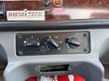 Control panel of a 2011 Freightliner M2 106 featuring dials for temperature and fan settings with labeled icons