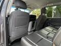 Interior view of a 2017 Chevrolet Tahoe showcasing the back seat area with black leather upholstery and a console between the seats
